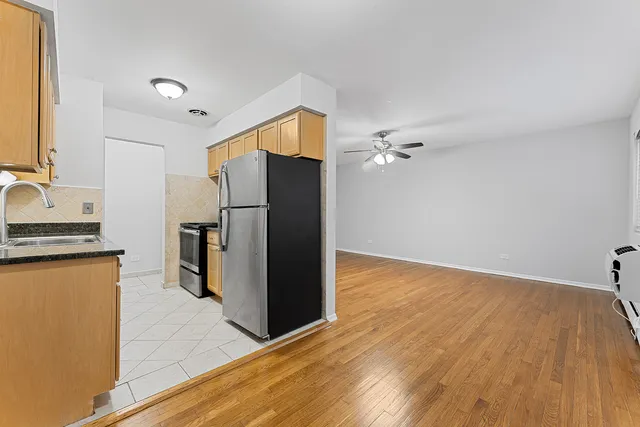a kitchen with granite countertop a refrigerator and a sink
