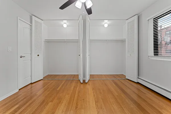a view of empty room with wooden floor