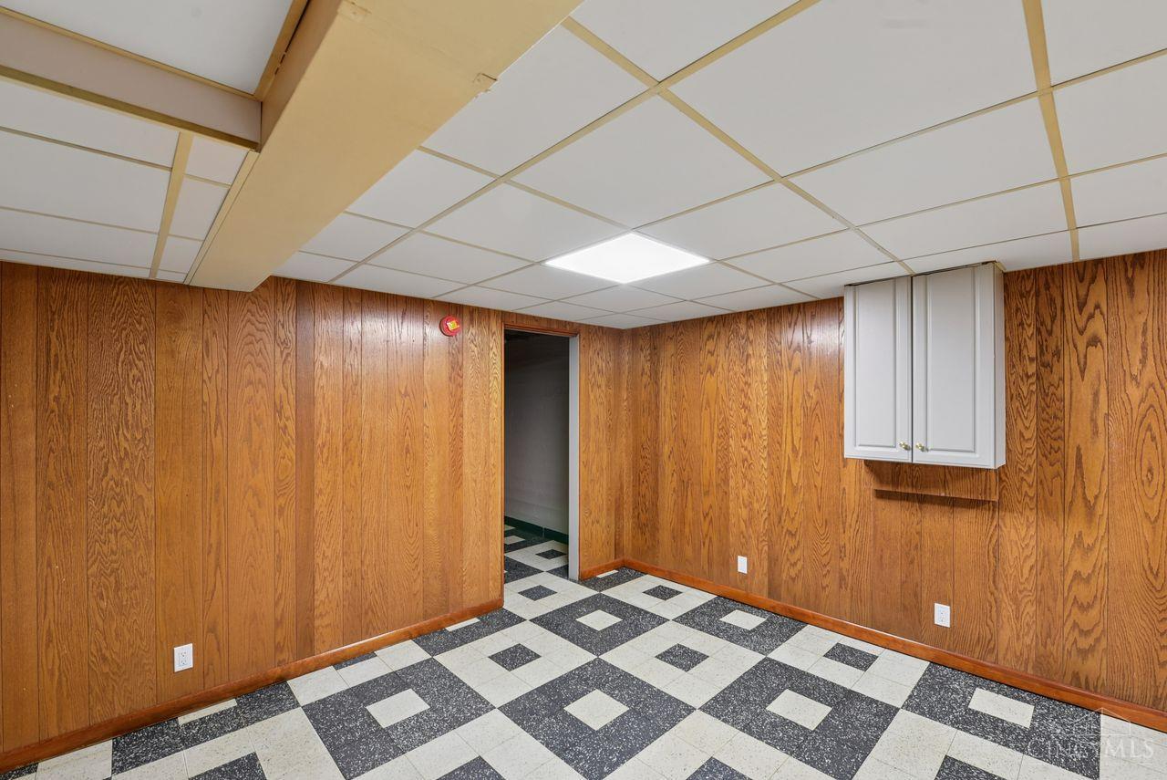 5258 Shepherd Road Cincinnati, OH 45223 - Photo 31 of 43 The Spacious Recreation Room is located in the Lower Level and features an attractive Tiled Floor, a Drop Ceiling with Lighting and Paneled Walls.