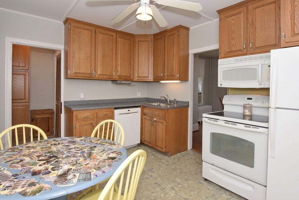 18 High Street Saugus, MA 01906 - Photo 6 of 35 a kitchen with a stove a sink and a refrigerator