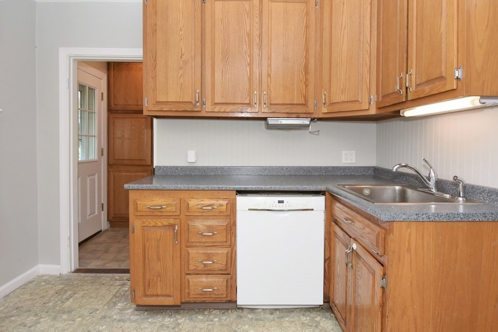 18 High Street Saugus, MA 01906 - Photo 8 of 35 a kitchen with granite countertop cabinets and sink
