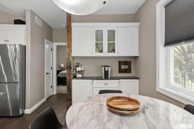 a bedroom that has a bed and a flat tv screen on the dresser