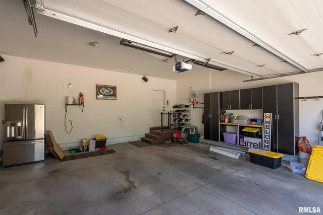 a view of a house with a yard and large tree