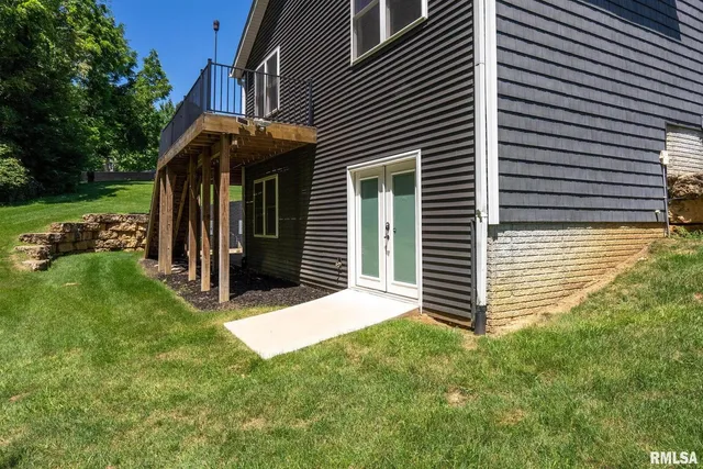 an aerial view of residential houses with outdoor space and trees