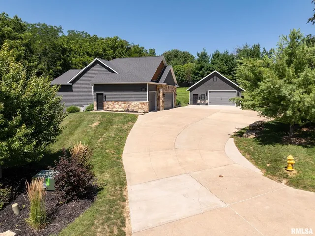 an aerial view of residential house with yard and swimming pool
