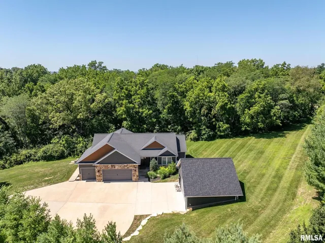an aerial view of a house with garden space and street view