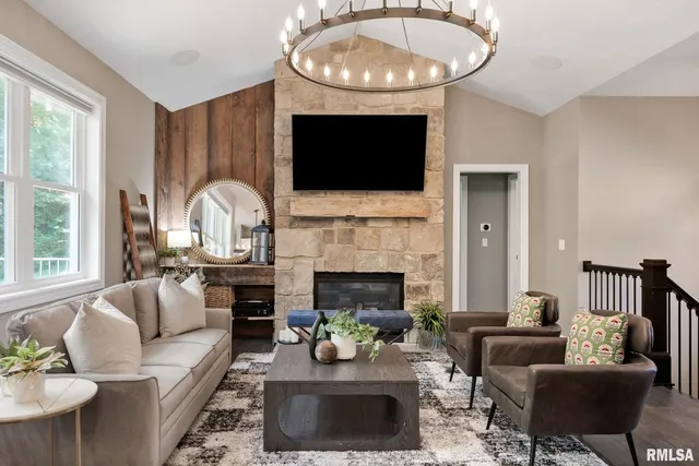 a living room with furniture a rug and a large window
