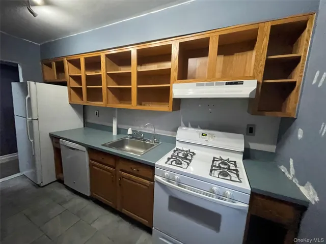 a kitchen with stainless steel appliances granite countertop a stove and a refrigerator