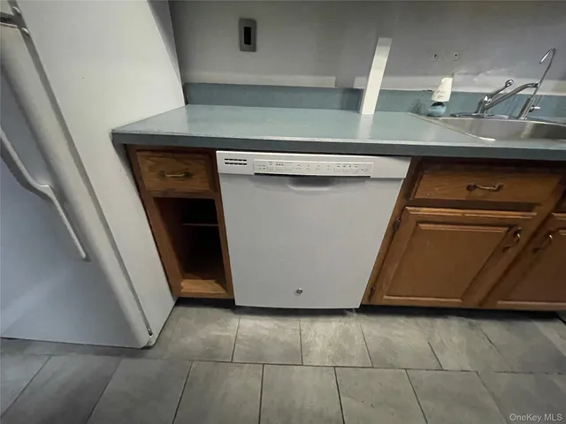 a utility room with wooden floor washer and dryer