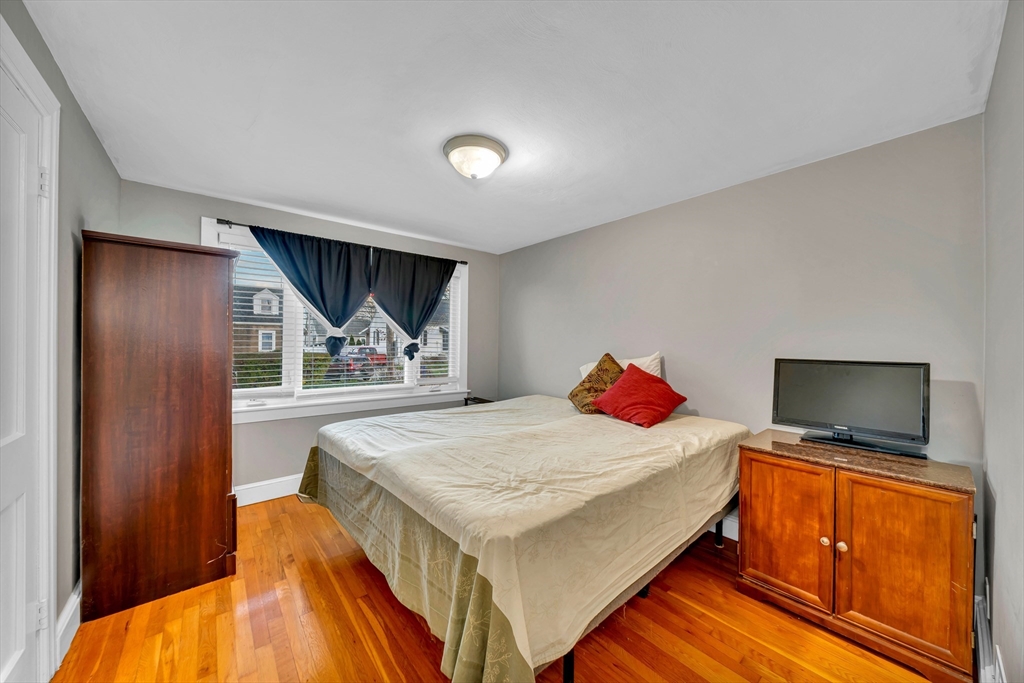 144 Orvis Road Revere, MA 02151 - Photo 18 of 42 a bedroom with a bed and a flat screen tv