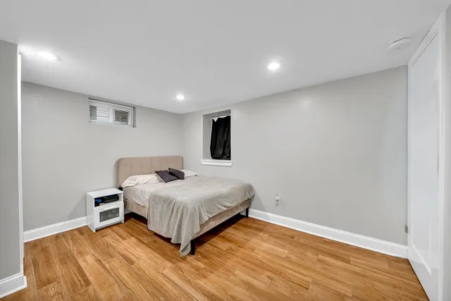 a bedroom with a bed and a wooden floor