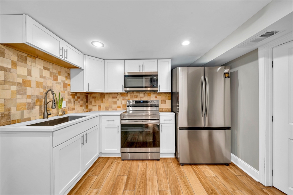 144 Orvis Road Revere, MA 02151 - Photo 23 of 42 a kitchen with a refrigerator sink and microwave