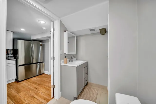 a kitchen with a refrigerator and a sink