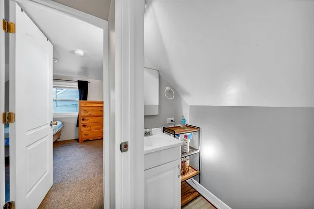 a view of a room that has a couch and a washing machine in a room