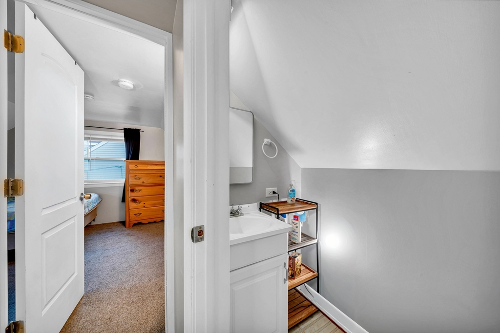 144 Orvis Road Revere, MA 02151 - Photo 30 of 42 a view of a room that has a couch and a washing machine in a room