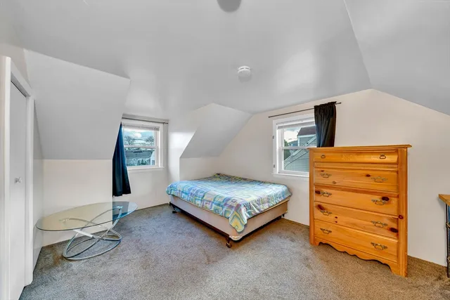 a bedroom with a bed and a mirror