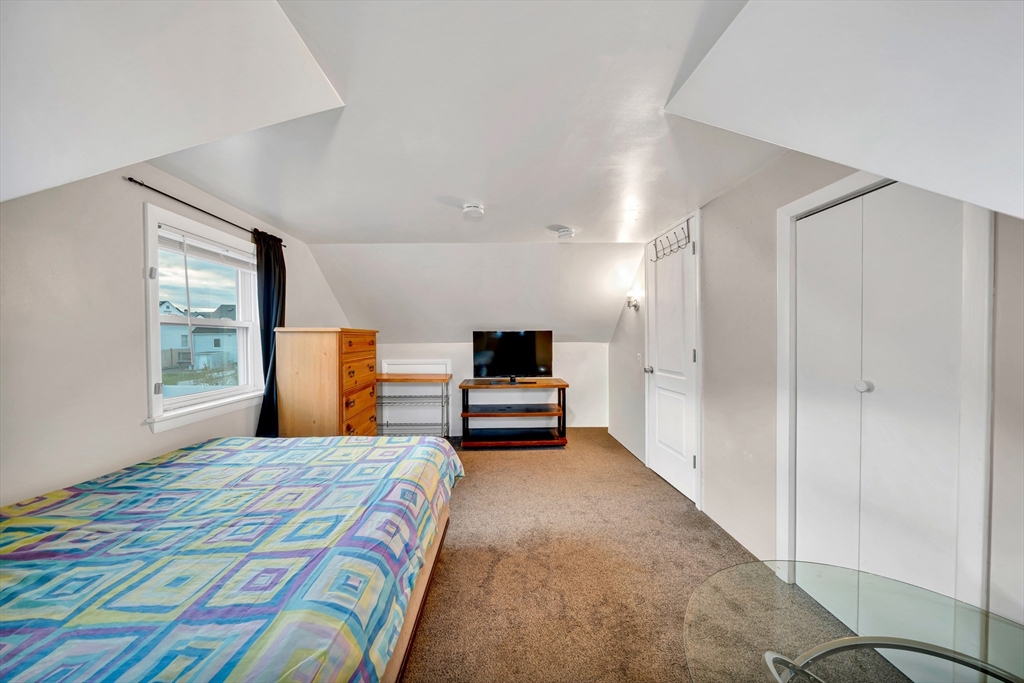 144 Orvis Road Revere, MA 02151 - Photo 32 of 42 a bedroom with a bed and a large window