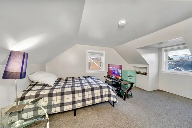 a bedroom with a bed and window