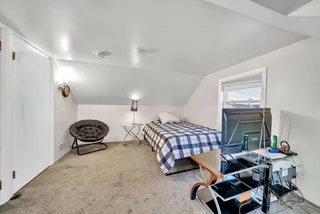 a bedroom with furniture and a window