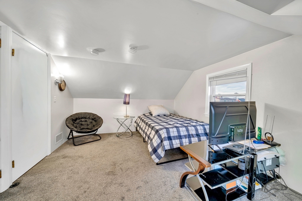 144 Orvis Road Revere, MA 02151 - Photo 34 of 42 a bedroom with furniture and a window