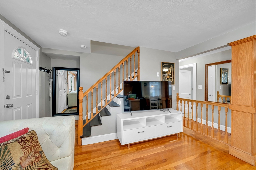 144 Orvis Road Revere, MA 02151 - Photo 6 of 42 a living room with furniture and a flat screen tv