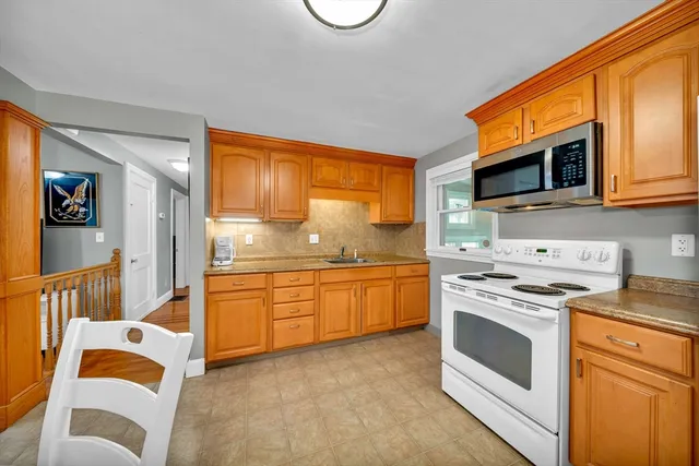 a kitchen with stainless steel appliances granite countertop a stove and a sink