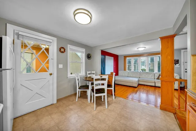 a dining room with furniture and a large window