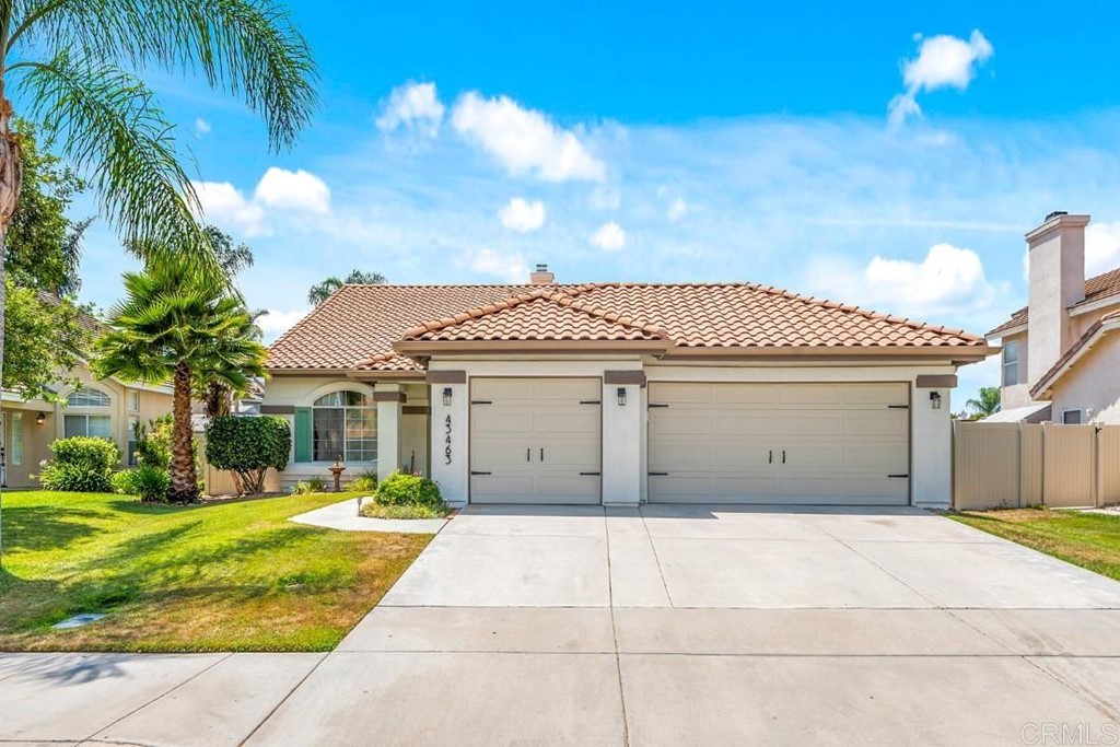 a view of a white house with a yard and plants