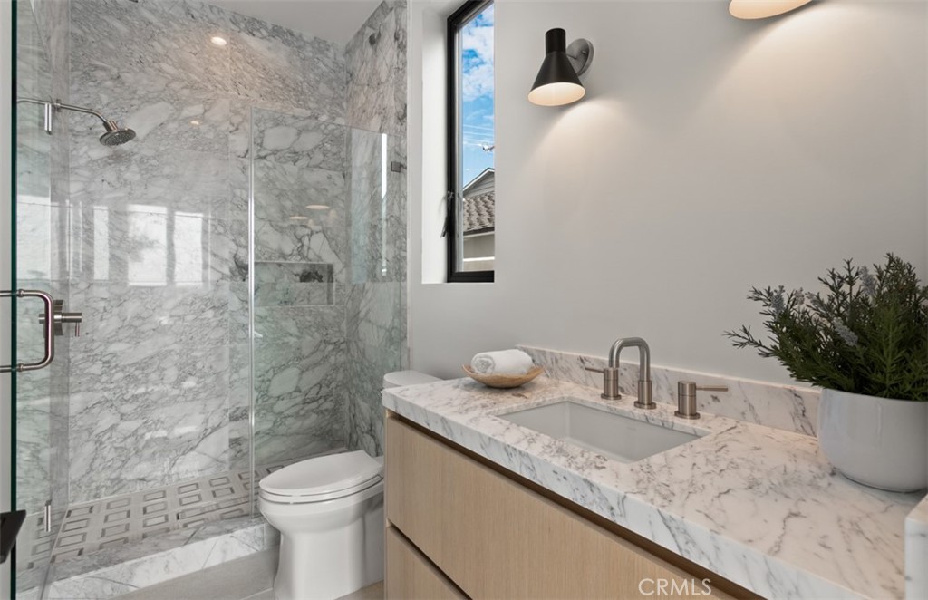 1210 Kings Road Newport Beach, CA 92663 - Photo 39 of 50 a bathroom with a granite countertop sink a toilet and shower