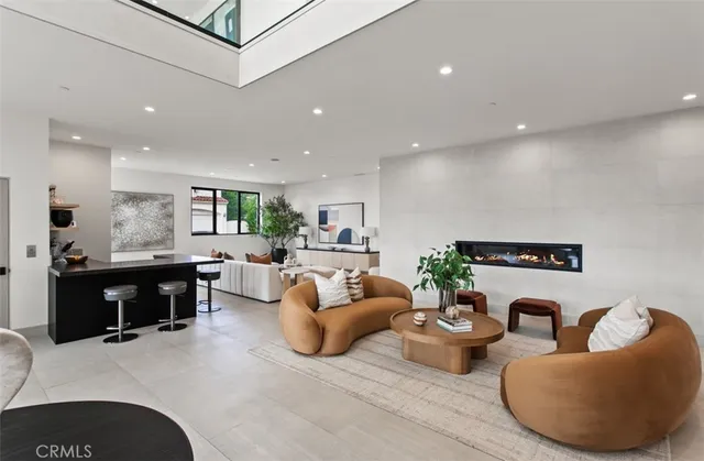 a living room with furniture and view of kitchen