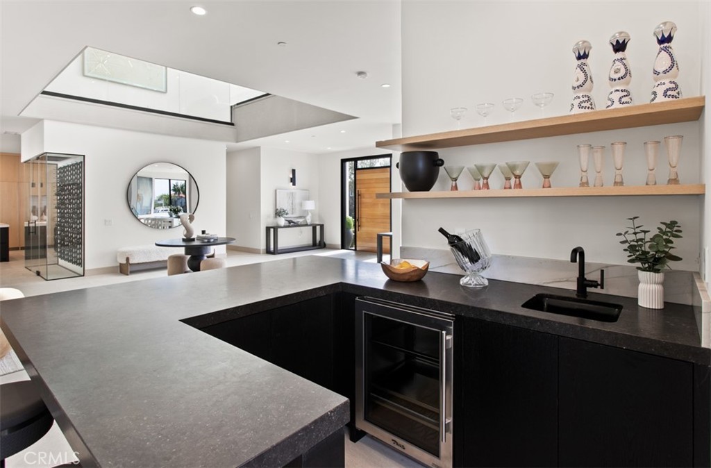 1210 Kings Road Newport Beach, CA 92663 - Photo 10 of 50 a kitchen with granite countertop a sink a stove and cabinets