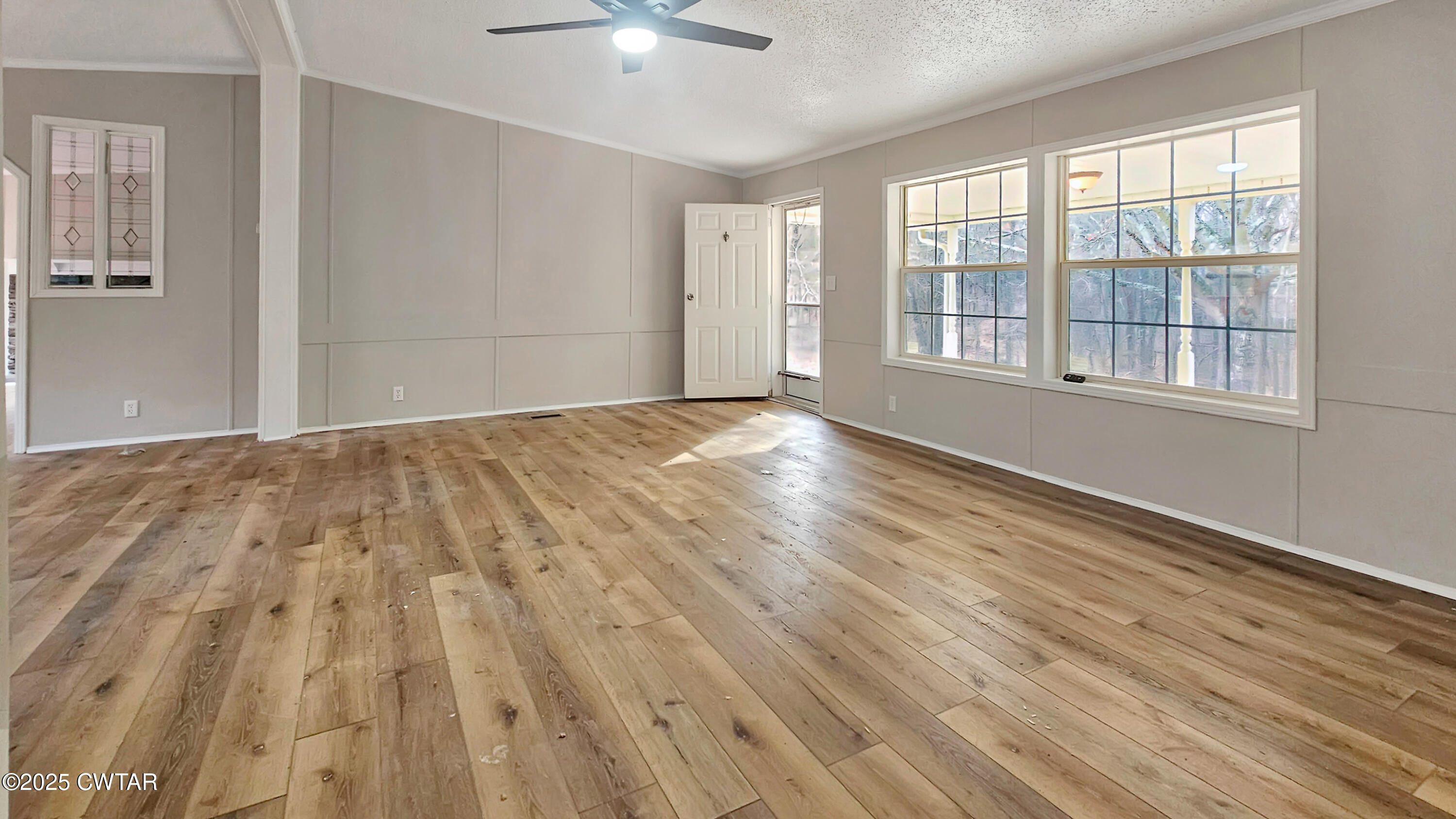 5427 Shades Bridge Road McKenzie, TN 38201 - Photo 13 of 35 a view of an empty room with a window and wooden floor