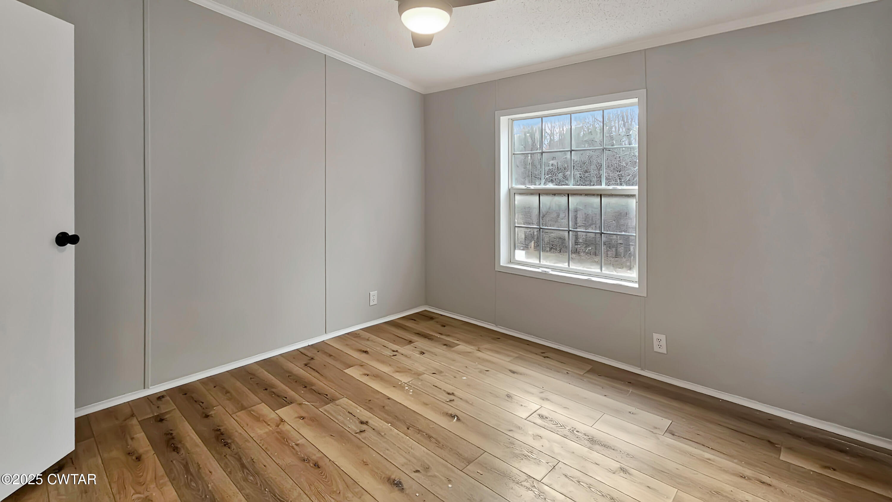 5427 Shades Bridge Road McKenzie, TN 38201 - Photo 16 of 35 a view of an empty room with wooden floor and a window