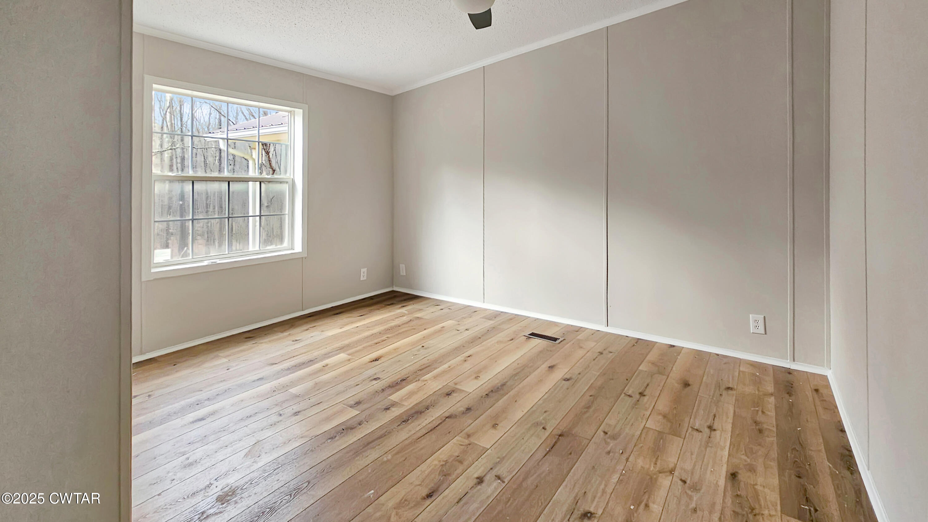 5427 Shades Bridge Road McKenzie, TN 38201 - Photo 17 of 35 an empty room with wooden floor and windows