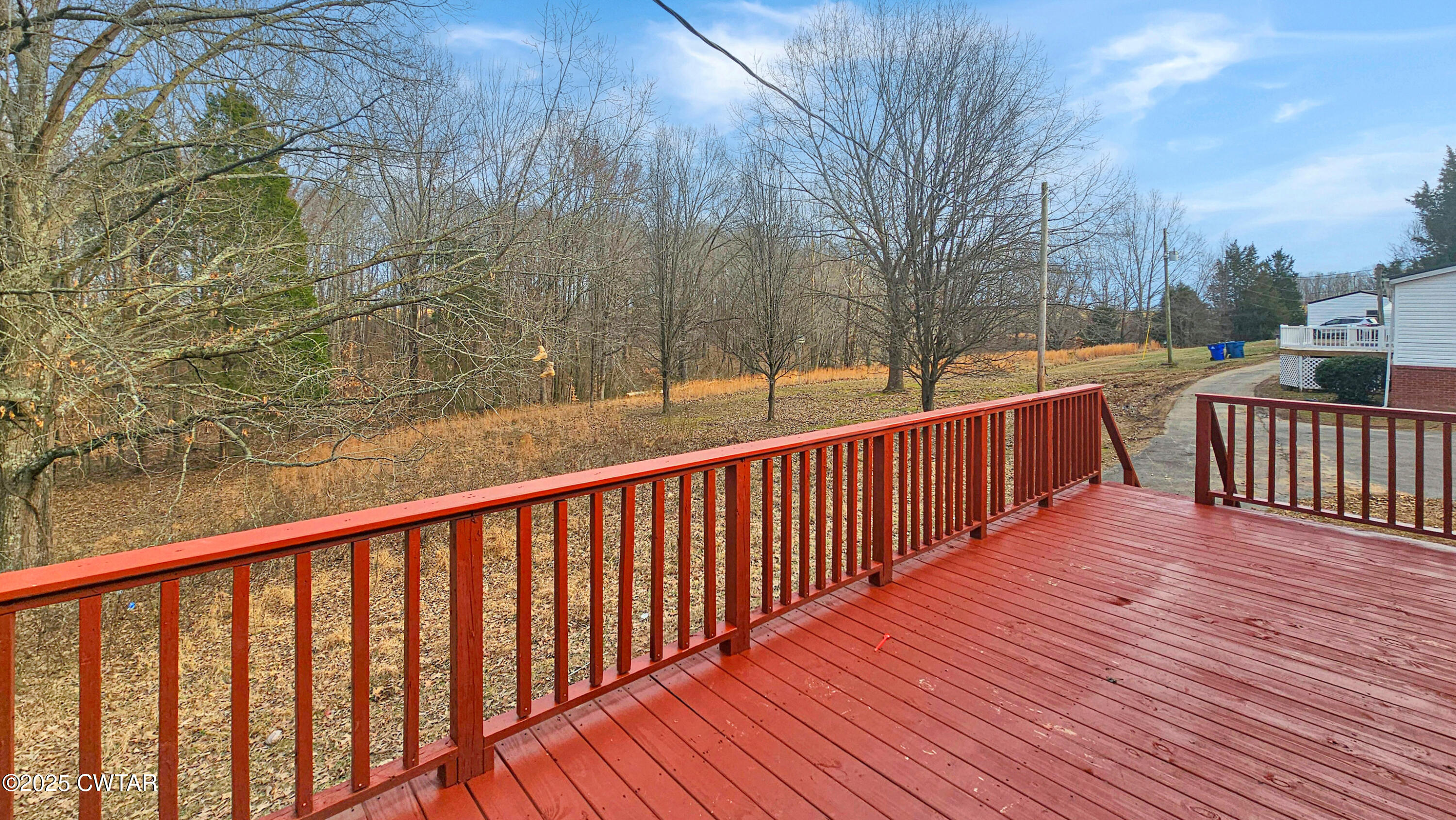 5427 Shades Bridge Road McKenzie, TN 38201 - Photo 19 of 35 a balcony with wooden floor and fence