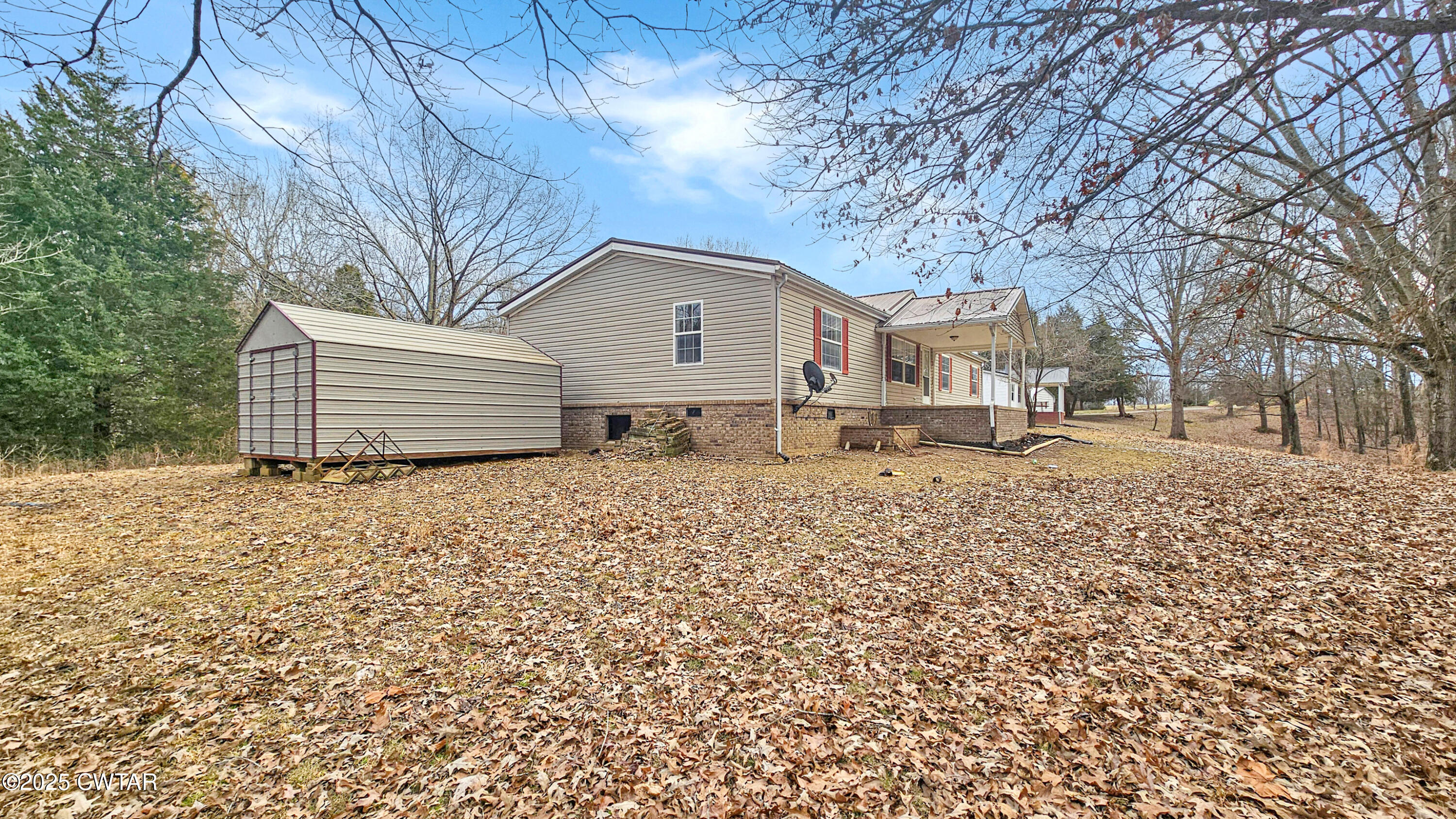 5427 Shades Bridge Road McKenzie, TN 38201 - Photo 20 of 35 a backyard of a house with a large tree