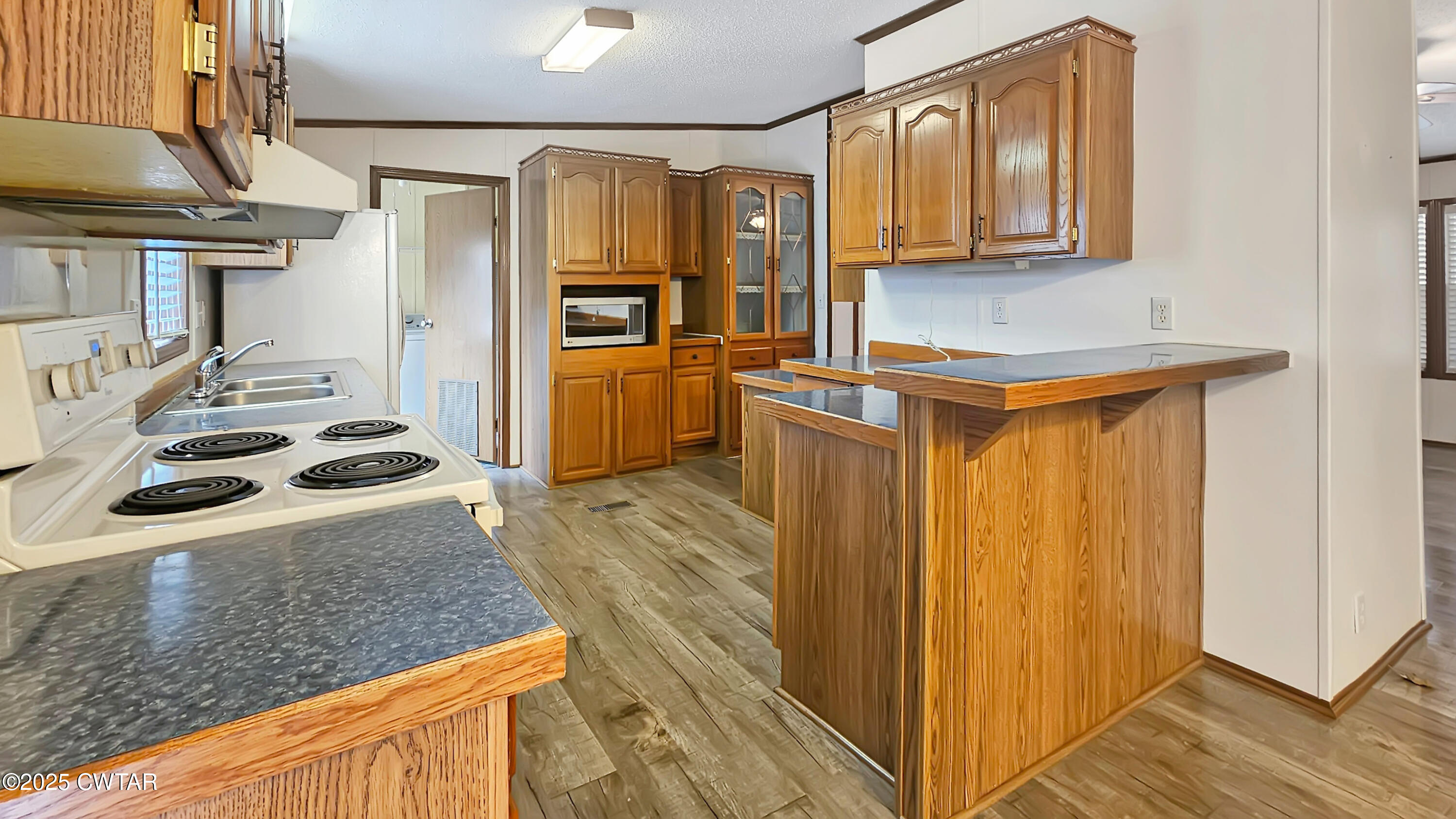 5427 Shades Bridge Road McKenzie, TN 38201 - Photo 22 of 35 a kitchen with stainless steel appliances granite countertop a sink stove and refrigerator