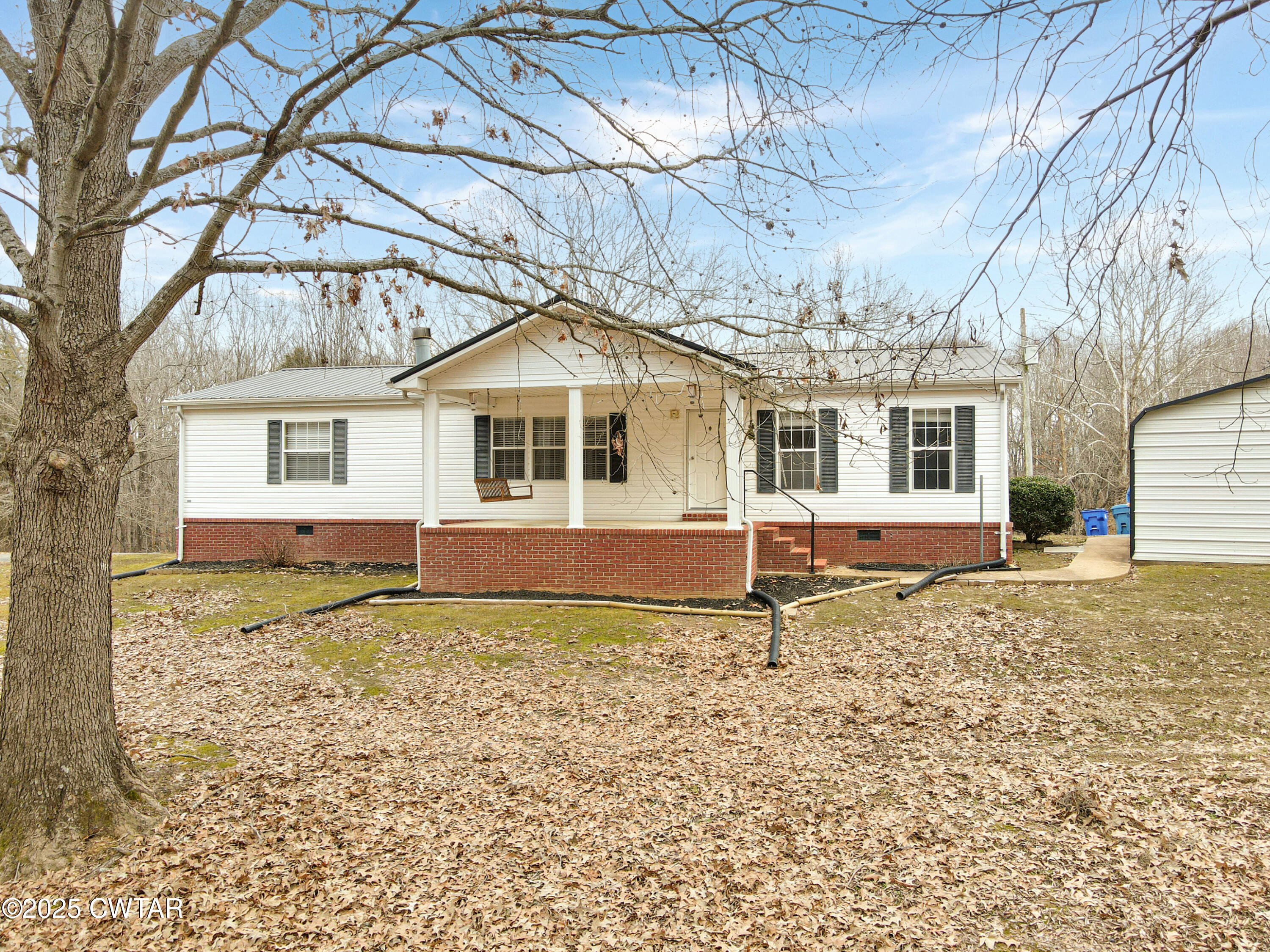 5427 Shades Bridge Road McKenzie, TN 38201 - Photo 3 of 35 a house with trees in the background
