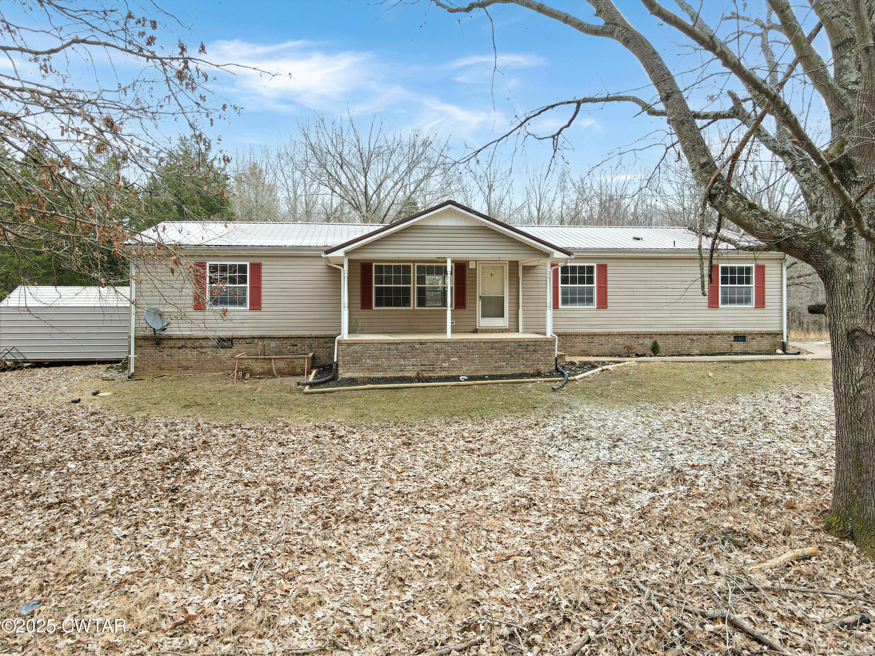 5427 Shades Bridge Road McKenzie, TN 38201 - Photo 4 of 35 a front view of a house with a garden