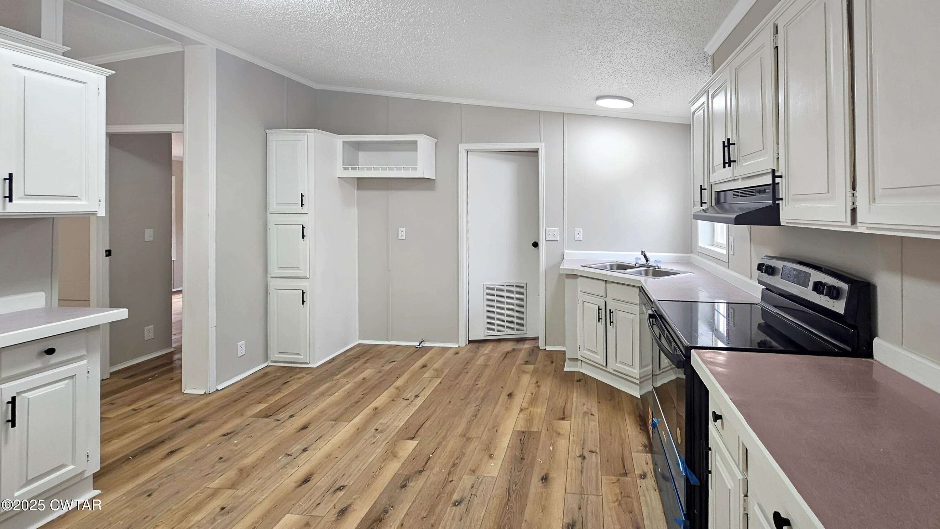 5427 Shades Bridge Road McKenzie, TN 38201 - Photo 8 of 35 a kitchen with a sink stove and refrigerator