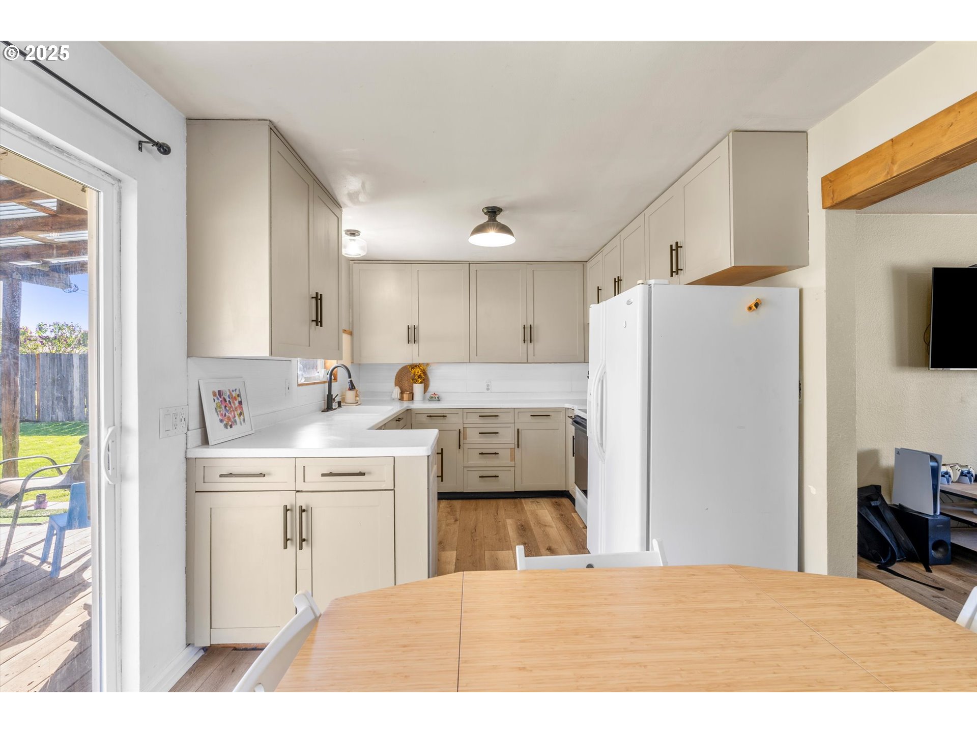 1379 Olympic Street Springfield, OR 97477 - Photo 14 of 33 a kitchen with stainless steel appliances kitchen island sink refrigerator and microwave