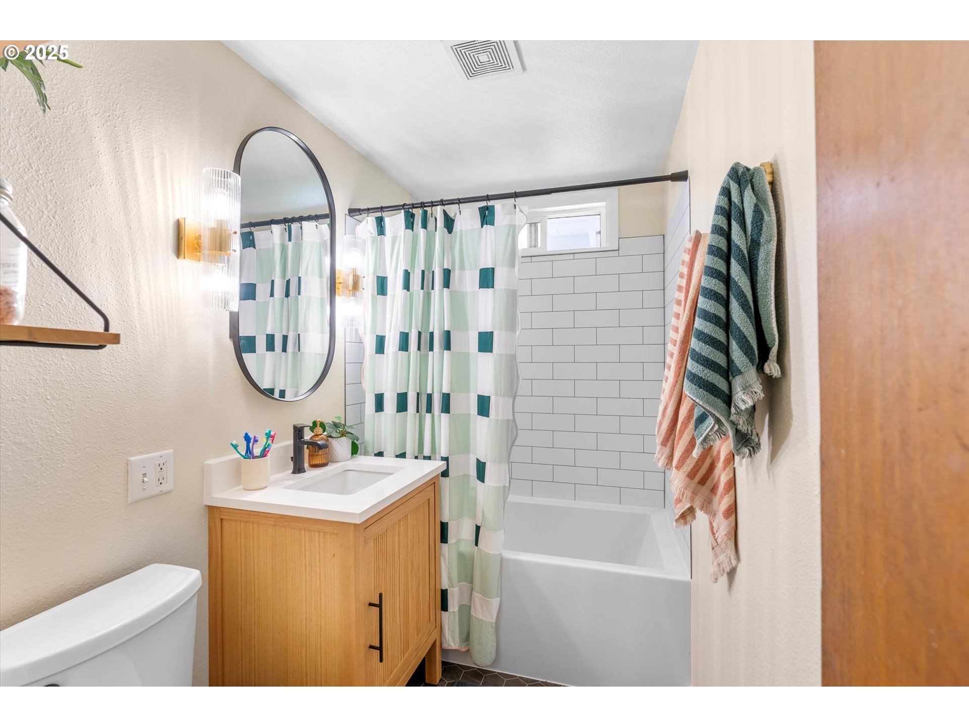 1379 Olympic Street Springfield, OR 97477 - Photo 17 of 33 a bathroom with a sink a mirror and a shower