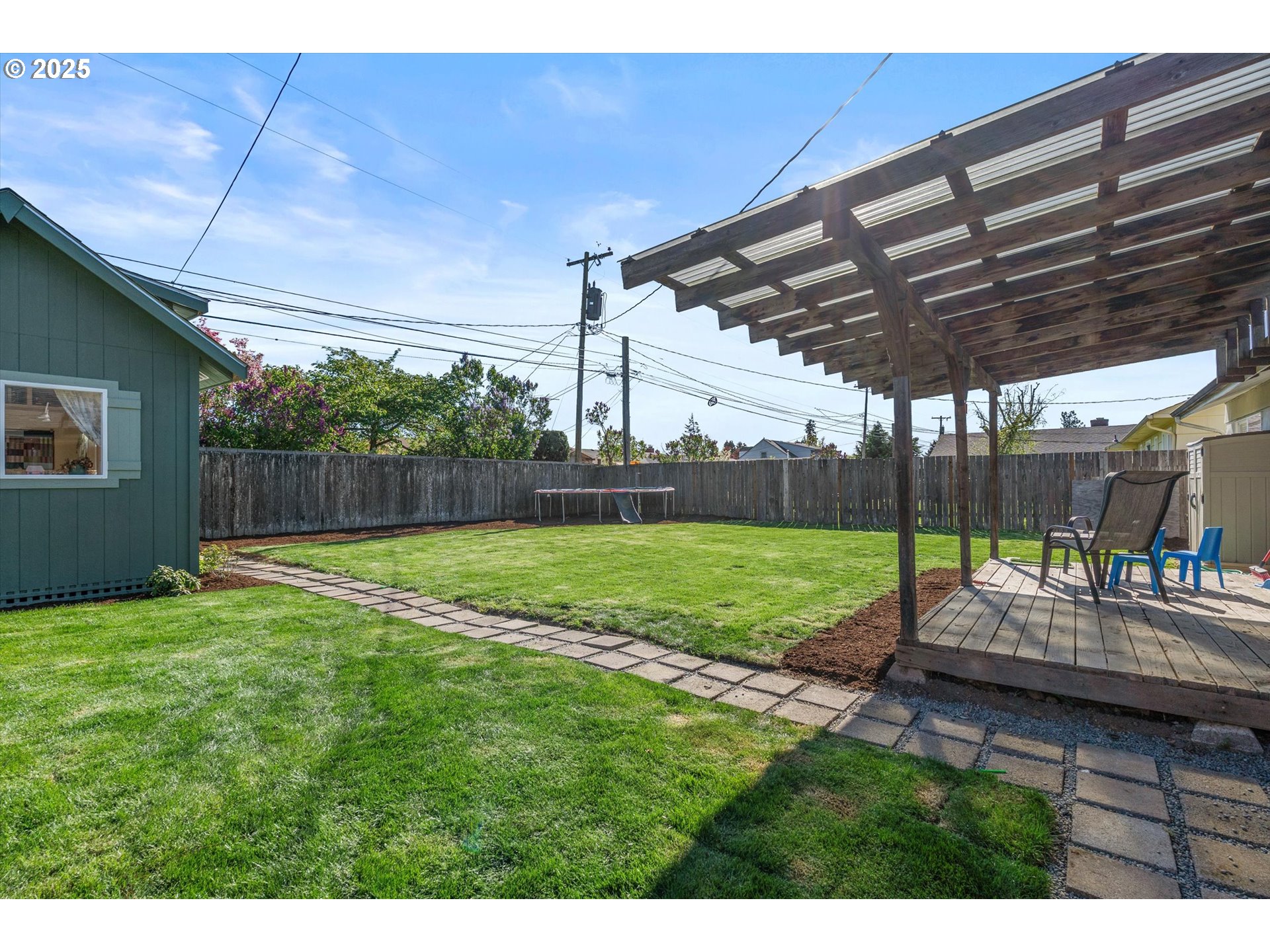 1379 Olympic Street Springfield, OR 97477 - Photo 23 of 33 a view of a backyard with table and chairs under an umbrella