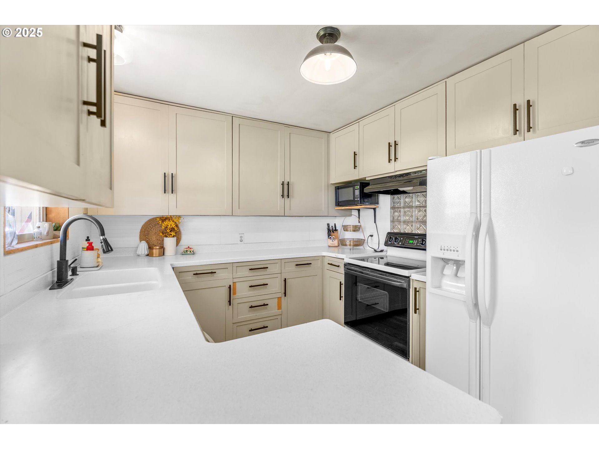 1379 Olympic Street Springfield, OR 97477 - Photo 8 of 33 a kitchen with a refrigerator stove and white cabinets
