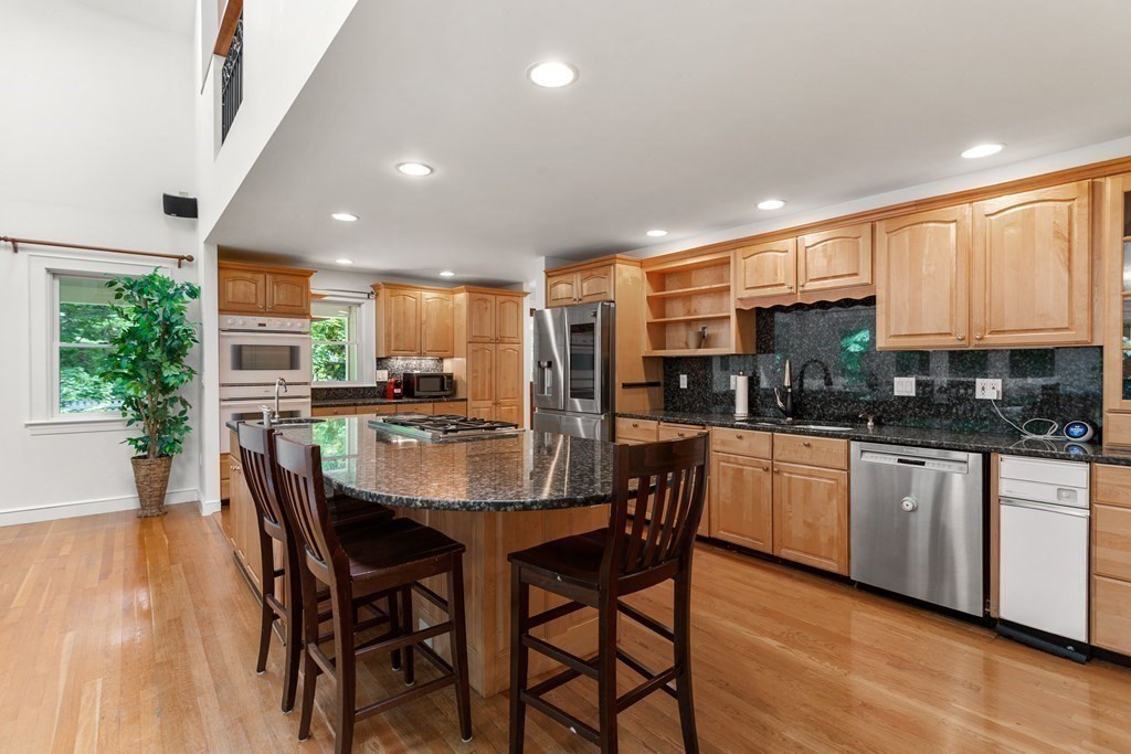 7 Phinney Road Lexington, MA 02421 - Photo 6 of 30 a kitchen with stainless steel appliances kitchen island granite countertop a kitchen island hardwood floor sink and stove