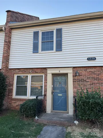 a view of a house with brick walls