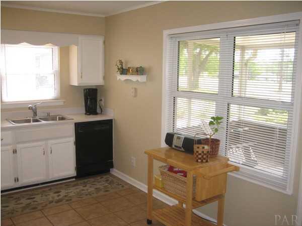 8823 Burning Tree Road Pensacola, FL 32514 - Photo 10 of 14 Another view of the Kitchen Looking Into Screen Porch and Golf Course