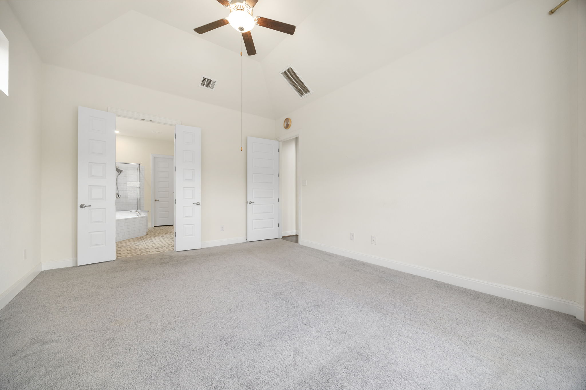1098 Cherrystone Loop Buda, TX 78610 - Photo 16 of 37 an empty room with a ceiling fan and a bathroom