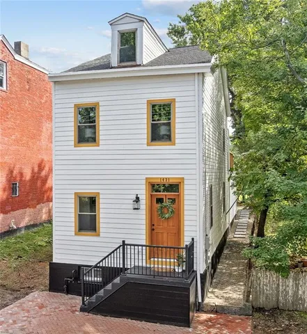 a view of a brick house with many windows