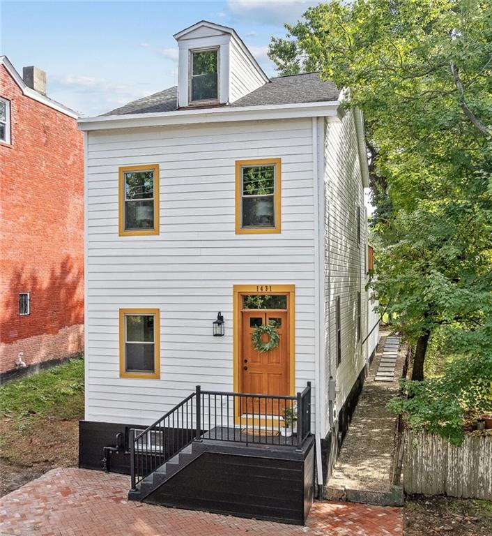 a view of a brick house with many windows